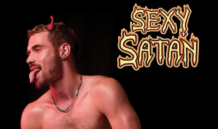 Shirtless man with red devil horns, sticking out tongue, beside 'Sexy Satan' text on black background