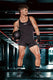 Athletic man in black singlet bodysuit holding medicine ball in gym, men's sporty underwear