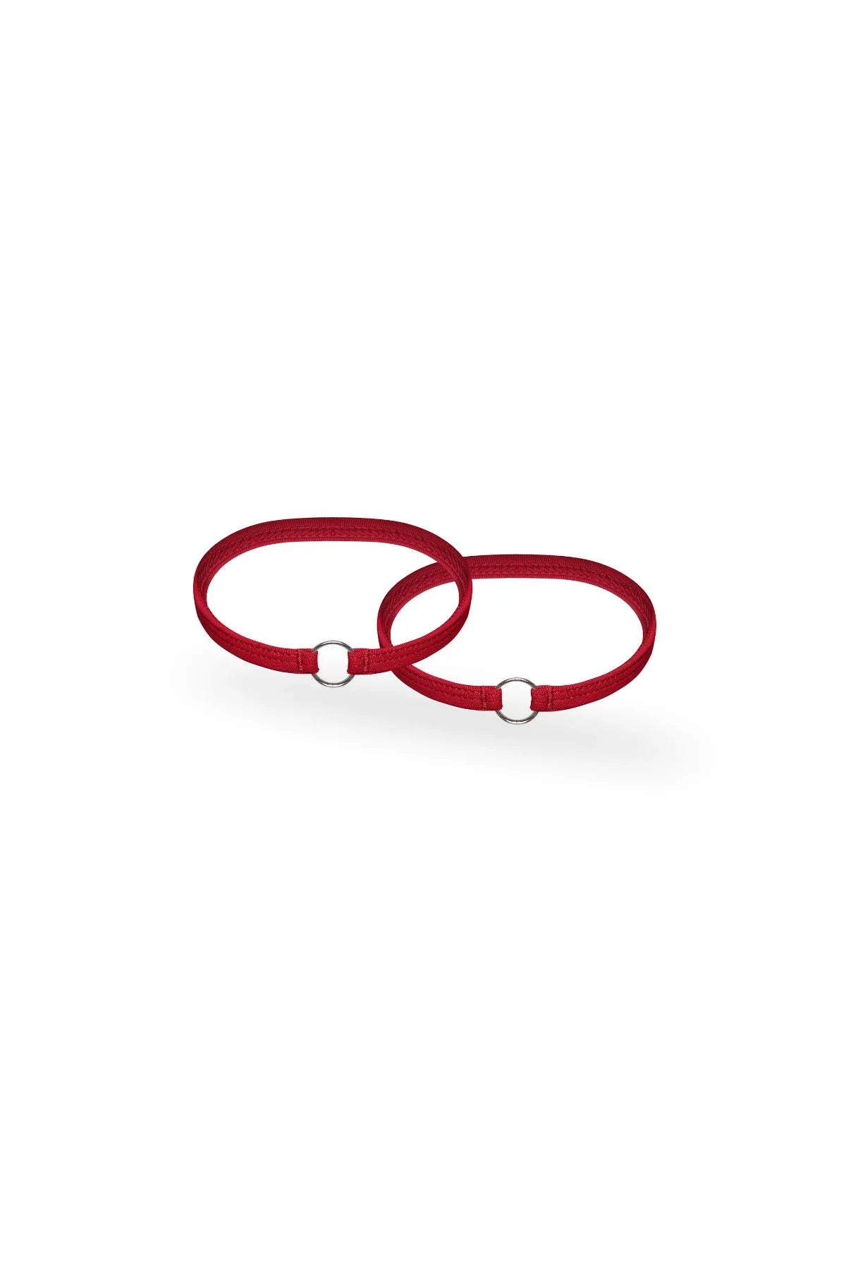 Red elastic harness straps with silver rings on a white background, men's accessory