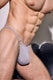 Male model in grey one-strap thong underwear, highlighting athletic physique.