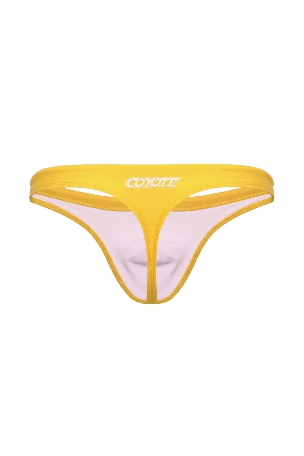Yellow men's swim thong with cut-out design and logo, isolated on white background.