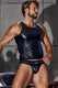 Man in black faux leather tank top and matching jockstrap underwear posing indoors