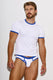 Man modeling white men’s underwear and ringer tee with blue trim against plain background