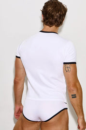 Man from behind wearing white ringer t-shirt and white briefs with black trim