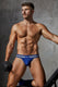 Athletic man in blue sporty briefs holding dumbbell, modeling men's underwear