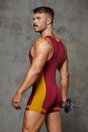 Muscular man in maroon and gold singlet holding dumbbell, athletic underwear model