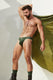 Muscular man modeling green men's jockstrap underwear outdoors, stylish and athletic look