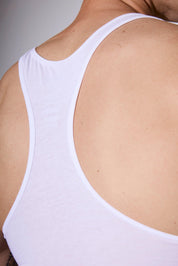 White men's tank top with racerback design, showcasing comfortable fit and sleek style for everyday wear.