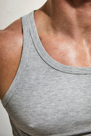 Close-up of a man's chest in a grey ribbed cotton tank top