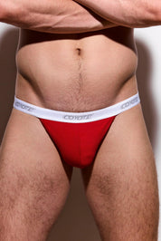 Man wearing red men's underwear with white logo waistband, athletic fit