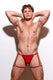 Male model in red strappy jockstrap underwear posing against a white background
