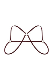 Bronze chest harness with minimalist straps and gold metal rings on white background