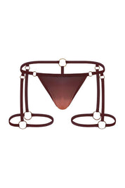 Bronze men's thong with harness straps and gold ring hardware, front view on white background