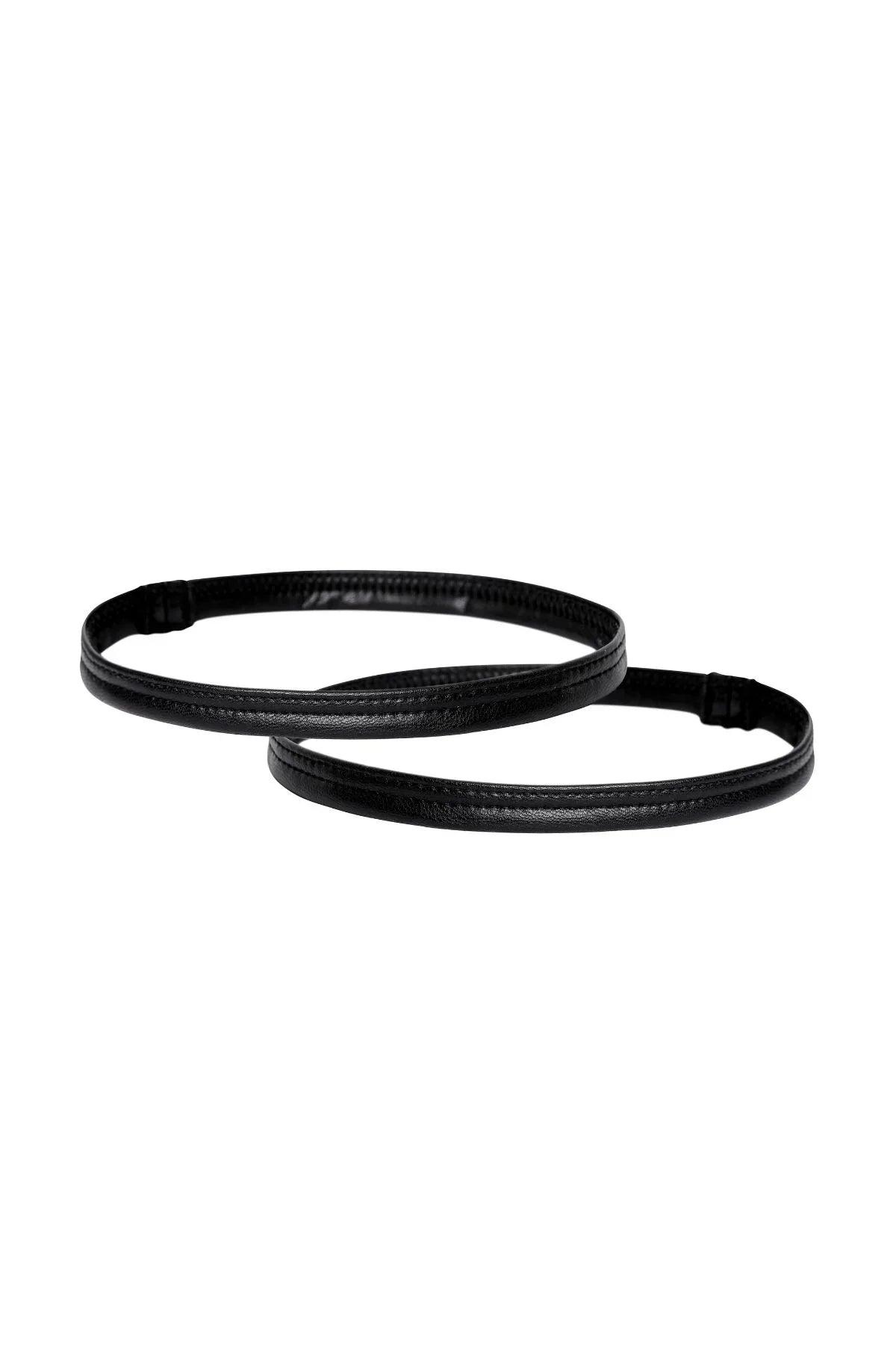Pair of black vegan leather leg bands on white background