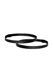Pair of black vegan leather leg bands on white background
