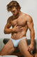 Shirtless muscular man in light blue men's underwear with white waistband posing indoors