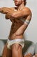 Bearded man posing in beige men's briefs with white waistband, stylish gay underwear